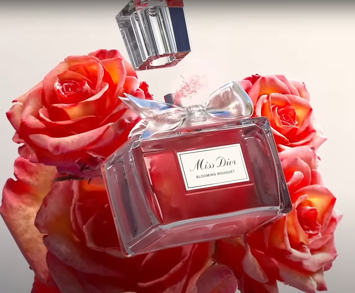 3D render: glass perfume bottle surrounded by red roses.