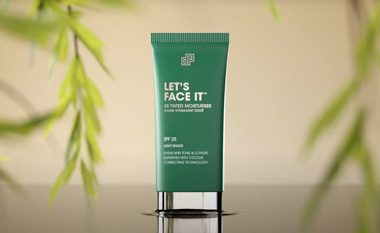 3D render: green moisturiser tube standing on a reflective surface with leaves.