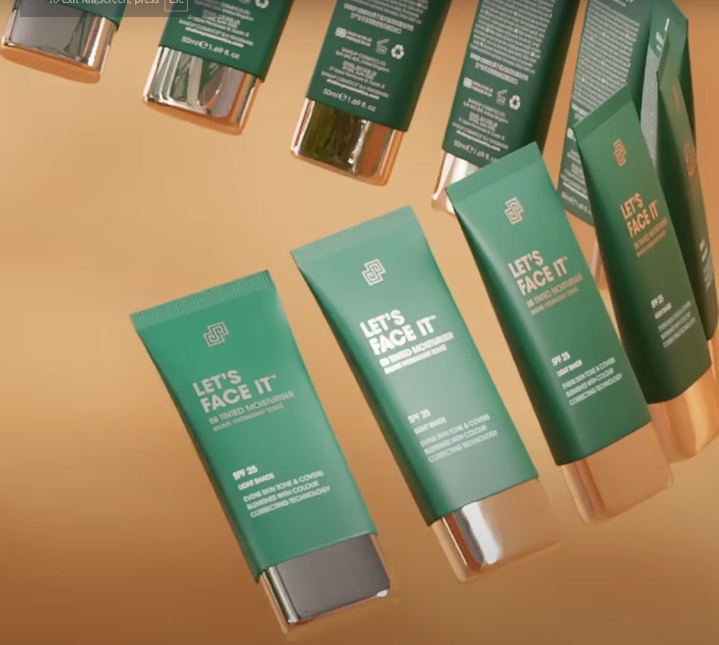 3D render: array of floating green moisturiser tubes on an amber gradient background.